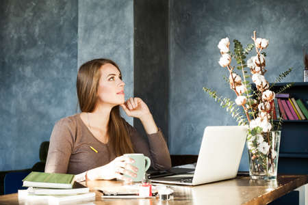 Designer Woman Working in Studio. Girl working with Creative Startup Project in Modern Loft. Generic...