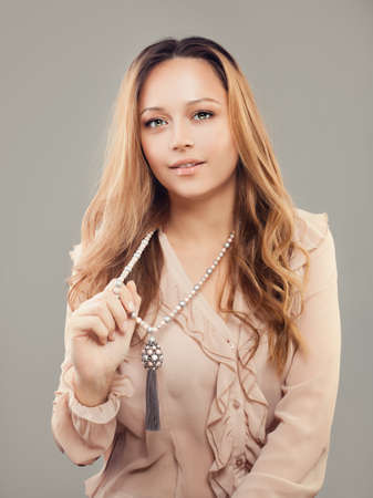 Beautiful Woman Fashion Model with Pearls Jewelry Necklacesの写真素材