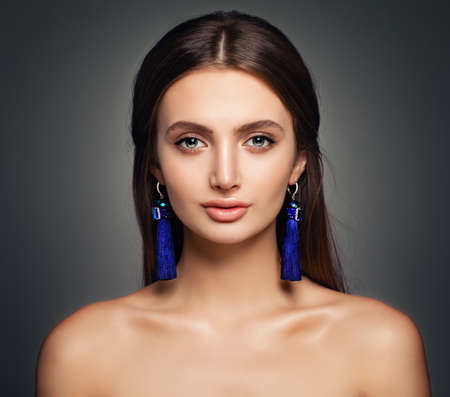 Fashion Portrait of Young Pretty Woman with Makeup and Blue Earringsの写真素材