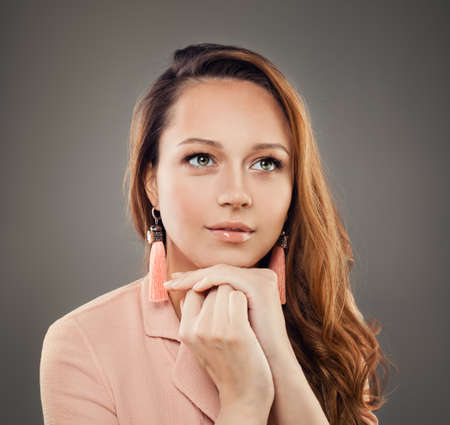 Cheerful Woman with Long Hair and Jewelry Earrings, Fashion Portraitの写真素材