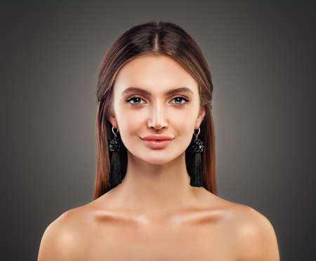Cute Woman Fashion Model with Shiny Skin, Makeup and Black Silky Jewellery Earrings Fashion Portraitの写真素材