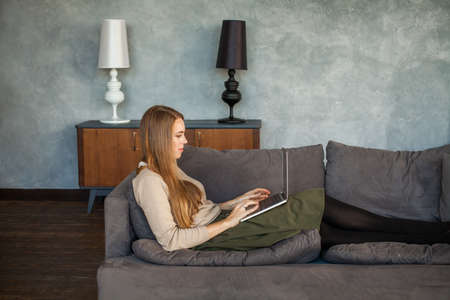 Young Woman Resting with Laptop at Home の写真素材