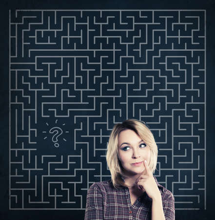 Thinking Woman with Labyrinth Background. Start-up, Business Planning and Strategy Conceptの写真素材