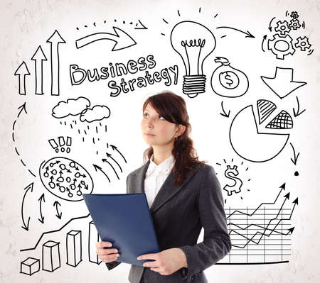 Businesswoman on Business Arrows, Light Bulb, Finance Icon and Marks Background.の写真素材