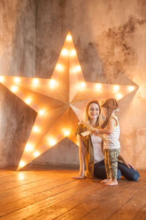 Nice Mom and her Small Child Playing in Studioの写真素材