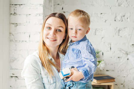 Closeup Portrait of Happy Sun and her Mom Hugging at Home Lifestyle Portrait.の写真素材