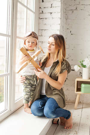 Happy Family Playing Together at Home with Plane Toysの写真素材