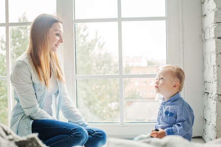 Funny Sun and her Mom at Home Lifestyle Portraitの写真素材