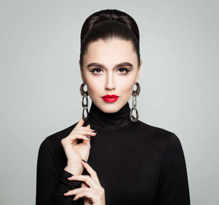 Fashion Beauty Portrait of Beautiful Woman Model in Black Roll Neck Cloth. Elegant Girl with Perfect Hairdo and Makeupの写真素材