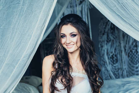 Happy Woman with Wedding Hairstyle and Bridal Makeup. Beautiful Female Faceの写真素材