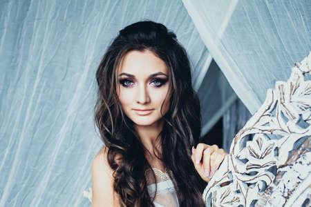 Perfect Young Woman with Wavy Hairstyle and Bridal Make up. Cute Female Model Faceの写真素材