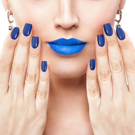 Woman Touching her Lips her Hand with Manicure. Makeup Lips with Trendy Blue Color Lipstickの写真素材
