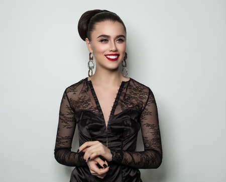 Laughing Woman Posing against Gray Wall Background Fashion Portraitの写真素材