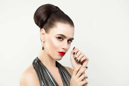 Stylish Woman showing Hands with Manicure Nails. Black Nail polish. Red Lips and Eyeliner Makeup. Perfect Female Model Faceの写真素材