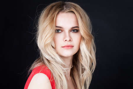 Young Perfect Woman with Blonde Hair on Black Backgroundの写真素材