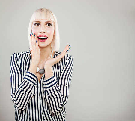 Surprised happy woman with opened mouth. Shocked fashion model womanの写真素材