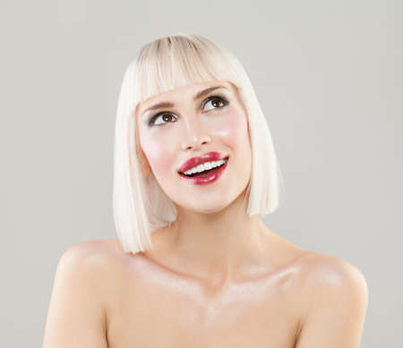 Pretty Blonde Girl with Healthy Skin and Bob Hairstyle on Gray Backgroundの写真素材