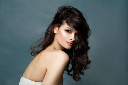 Fashion Portrait of Beautiful Curly Hair Woman on Banner Background with Copy spaceの写真素材