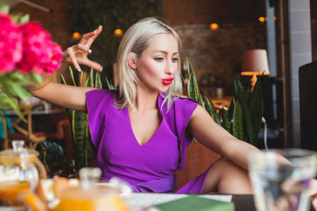 Cute Woman talking with friends in Restaurantの写真素材