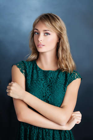 Fashion Portrait of Perfect Woman Model with Blonde Hair on Blue Backgroundの写真素材