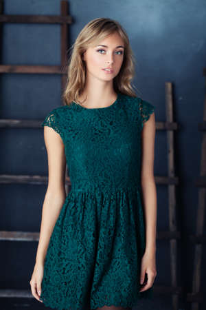 Blonde Woman in Green Dress Posingの写真素材