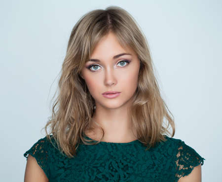Nice young woman on white background, closeup portraitの写真素材