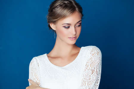 Young friendly woman on blue background. Young Beautyの写真素材