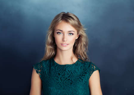 Smiling model woman on blue background. Young woman faceの写真素材