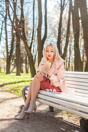 Cute Young Woman with Street Food Outdoorsの写真素材