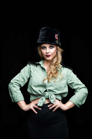 Beauty portrait of young woman fashion model in military style clothの写真素材