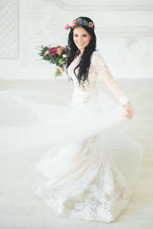 Beautiful Young Woman Fiancee in White Dress. Bride in Motionの写真素材