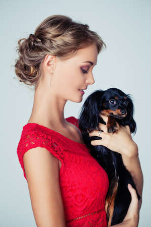 Pretty Young Woman with Little Dog on White Background, Portrait. Love Pets Conceptの写真素材