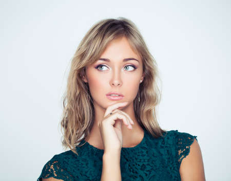 Thinking woman with her hand at her faceの写真素材