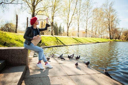 Young woman in red french beret hat in park outdoorsの写真素材