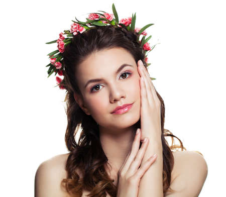 Young Woman with Perfect Hairstyle, Makeup and Flowers Isolated on White Backgroundの写真素材