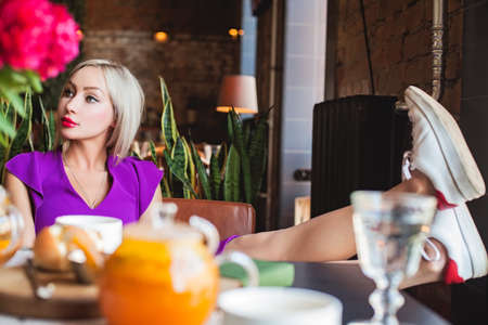 Young casual woman relaxing in cafeの写真素材