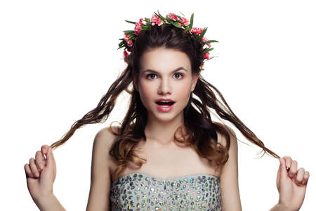 Happy Woman with Perfect Hairstyle, Makeup and Flowers Isolated on White Backgroundの写真素材