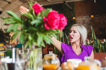 Woman Calling the Waiter in Restaurantの写真素材