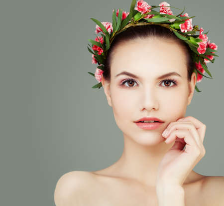 Perfect Girl with Healthy Skin and Flowers on Grey Background with Copy spaceの写真素材