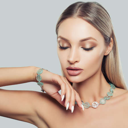 Nice Blonde Hair Woman Wearing Jewelry Necklace and Bracelet, Fashion Beauty Portrait. Glamorous Makeup and Accessoriesの写真素材