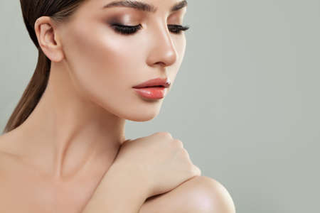 Beautiful young woman with clean skin. Girl beauty face care. Facial treatment.の写真素材