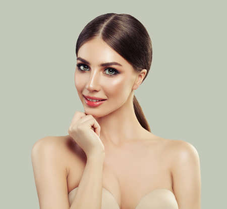 Cheerful Woman with Healthy Skin Smiling on White Background. Product Placement and Advertising Marketing Concept . Presenting your product. Expressive facial expressions.の写真素材