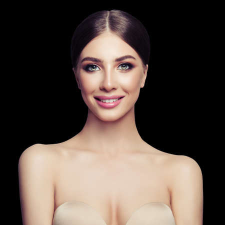 Beautiful female model smiling. Young woman face on black backgroundの写真素材