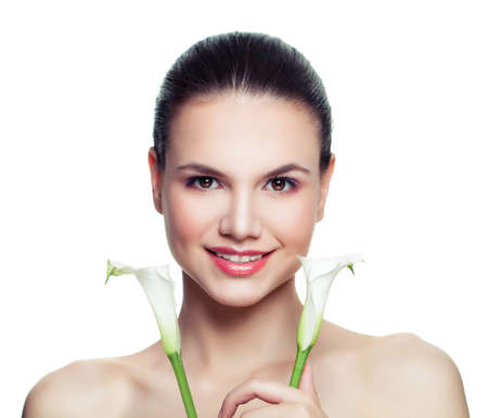 Spa woman with white flower isolated on white, portrait. Beautiful female model face. Facial treatment, cosmetology, skincare and spa conceptの写真素材