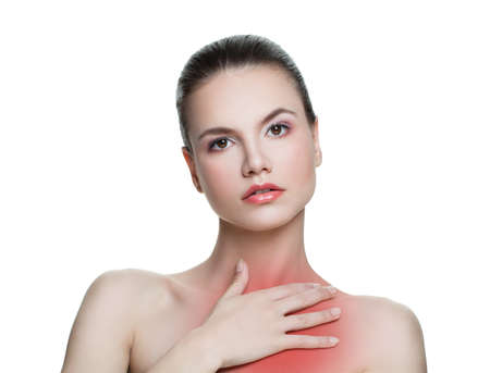 Young woman having a pain in a chest neck area isolated on white backgroundの写真素材