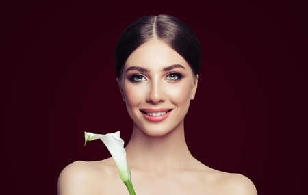 Spa girl portrait. Perfect young woman with healthy skin and flowerの写真素材