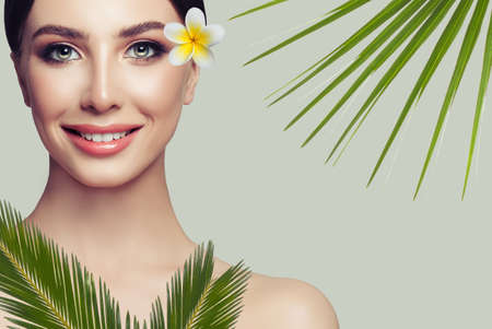 Beautiful young woman with clean fresh skin smiling. Girl beauty face. Facial treatmentの写真素材