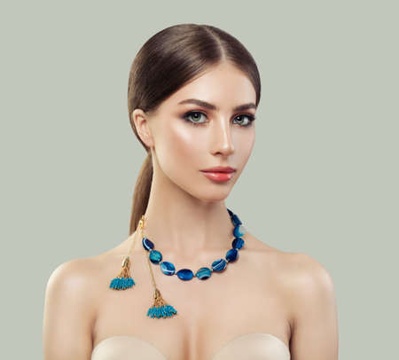 Beautiful woman with jewelry necklace portrait. Jewelry for woman, necklace with blue stones. Beauty and accessories.の写真素材