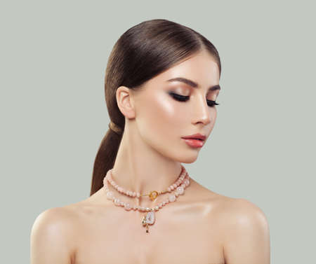 Young woman with jewelry portrait. Jewelry for woman, necklace with gemstones. Beauty and accessories.の写真素材