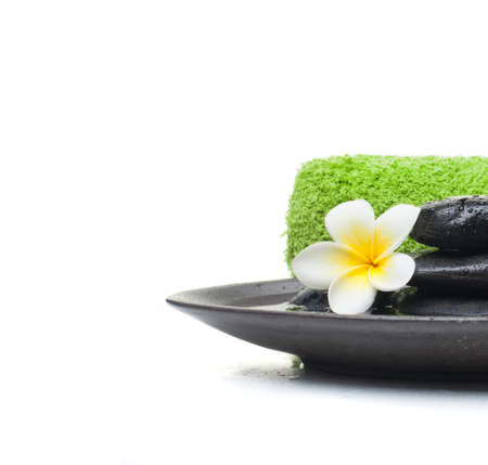 Spa Set with stones and towel and leaves on black plateの写真素材